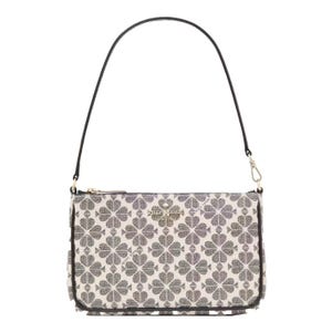 A handbag featuring a clover pattern on a light background with a detachable black shoulder strap and a gold-tone logo on the front.
