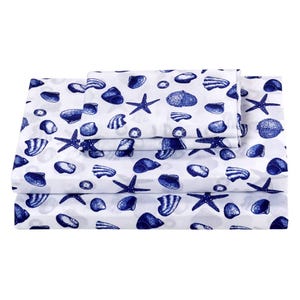 A bed sheet set with a nautical theme, featuring blue seashells and starfish on a white background.