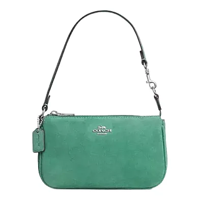 Green suede handbag with a detachable short strap, featuring a silver-tone brand logo and a matching tag.