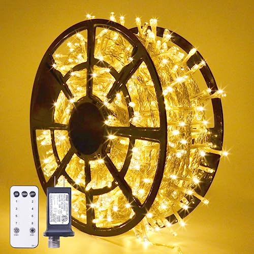 A spool of warm white LED Christmas lights accompanied by a remote control, designed for indoor or outdoor use.