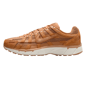 A tan athletic shoe with mesh and suede details, featuring a swoosh logo on the side and a white midsole with a gum outsole.