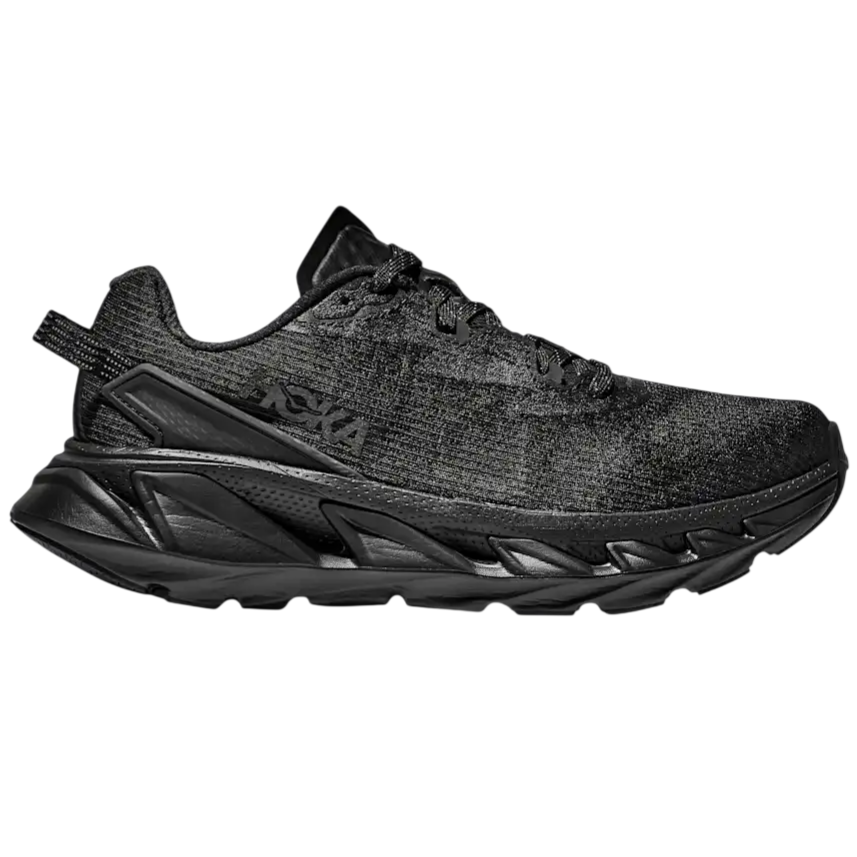 A black HOKA running shoe with a thick, textured sole and a knit upper. The design features a low-top silhouette and intricate detailing on the midsole.