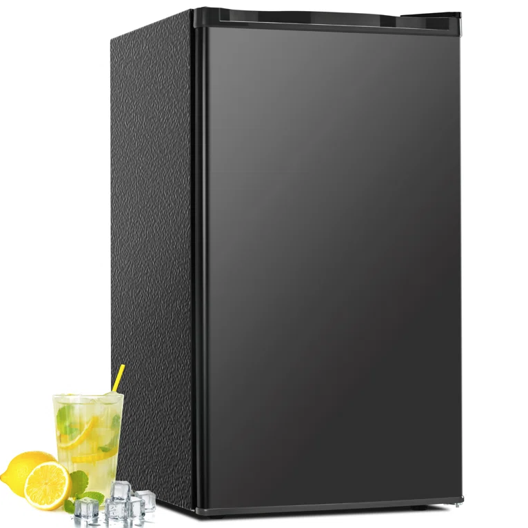 A sleek black mini fridge is shown with a glass of lemonade, lemon slices, and ice cubes placed beside it.