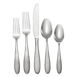 A hammered stainless steel flatware set consisting of a dinner fork, salad fork, knife, tablespoon, and teaspoon.
