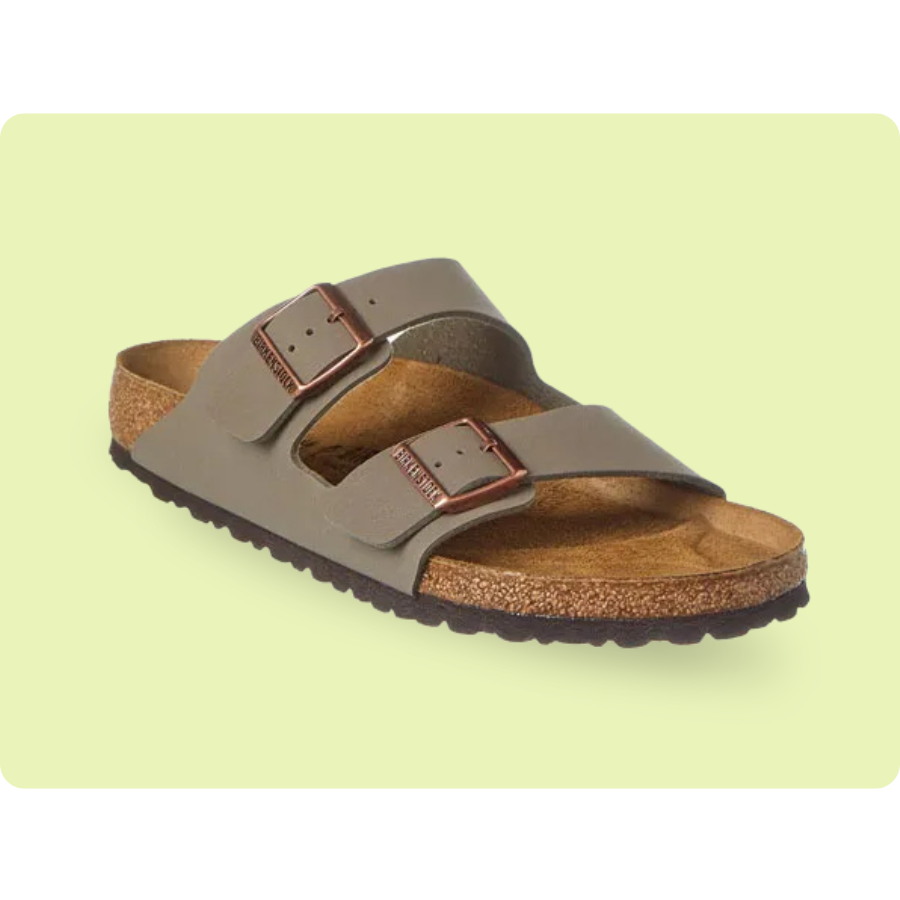 A sandal with two adjustable straps and buckles, featuring a cork footbed and a rubber sole, displayed on a light green background.