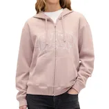 A person wearing a light pink GAP zip-up hoodie with white floral embroidery on the logo, paired with dark jeans.