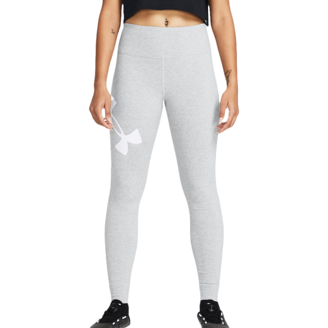 A person is wearing light gray leggings with a large white logo on the side, paired with a black crop top and black sneakers.
