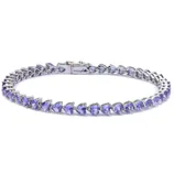 A silver tennis bracelet featuring heart-shaped lavender gemstones arranged in a continuous line with a secure clasp.