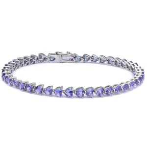 A silver tennis bracelet featuring heart-shaped lavender gemstones arranged in a continuous line with a secure clasp.
