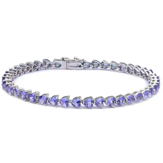 A silver tennis bracelet featuring heart-shaped lavender gemstones arranged in a continuous line with a secure clasp.