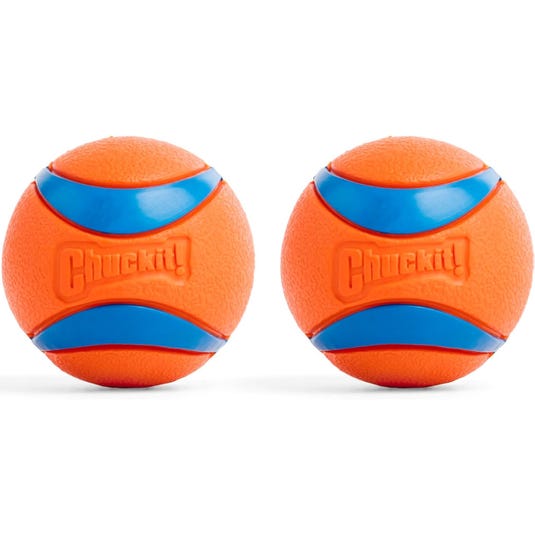 Two orange and blue Chuck-It dog toy balls designed for fetch, featuring a textured surface for easy grip.
