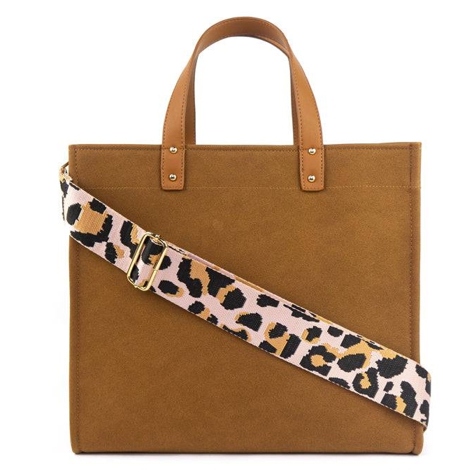 A brown tote bag featuring dual top handles and a wide pink shoulder strap with a leopard print pattern.