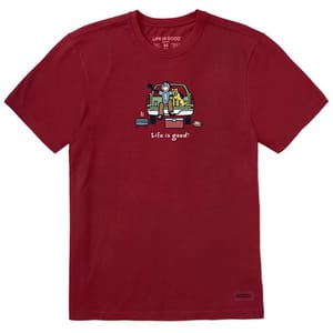 A red T-shirt featuring a cartoon design of a person, a dog, and a football in a truck bed, with the text \“Life is good.\“