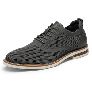 A gray lace-up shoe with a mesh upper, leather accents, and a white and brown sole, combining casual and formal elements for versatile use.