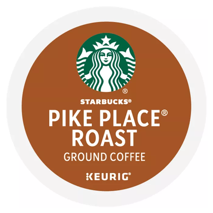 Starbucks Pike Place Roast ground coffee K-Cup pod for Keurig is shown, featuring a brown label with the Starbucks logo.