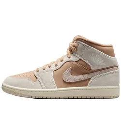 A mid-top sneaker in beige and tan tones with a suede texture, featuring a prominent swoosh and embossed details on the ankle.