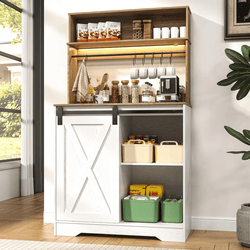 A freestanding kitchen storage cabinet with a farmhouse-style sliding barn door, open shelving for dry goods, a coffee maker, and wall hooks for cups. It includes bins for organized storage.