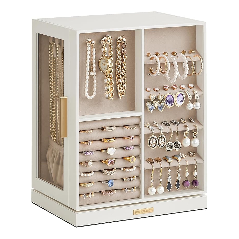 A white jewelry organizer features sections for hanging necklaces and bracelets, ring rolls, and slots for earrings and watches, with clear side panels for easy viewing.