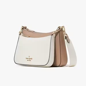 A Kate Spade shoulder bag featuring a color-block design with white, beige, and taupe sections and gold-tone hardware.