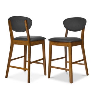 Two wooden bar stools with dark gray upholstered seats and backrests, featuring mid-century style design.