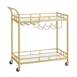 A gold metal bar cart with two mirrored shelves, wine glass holders, and bottle racks, featuring four black caster wheels for mobility.