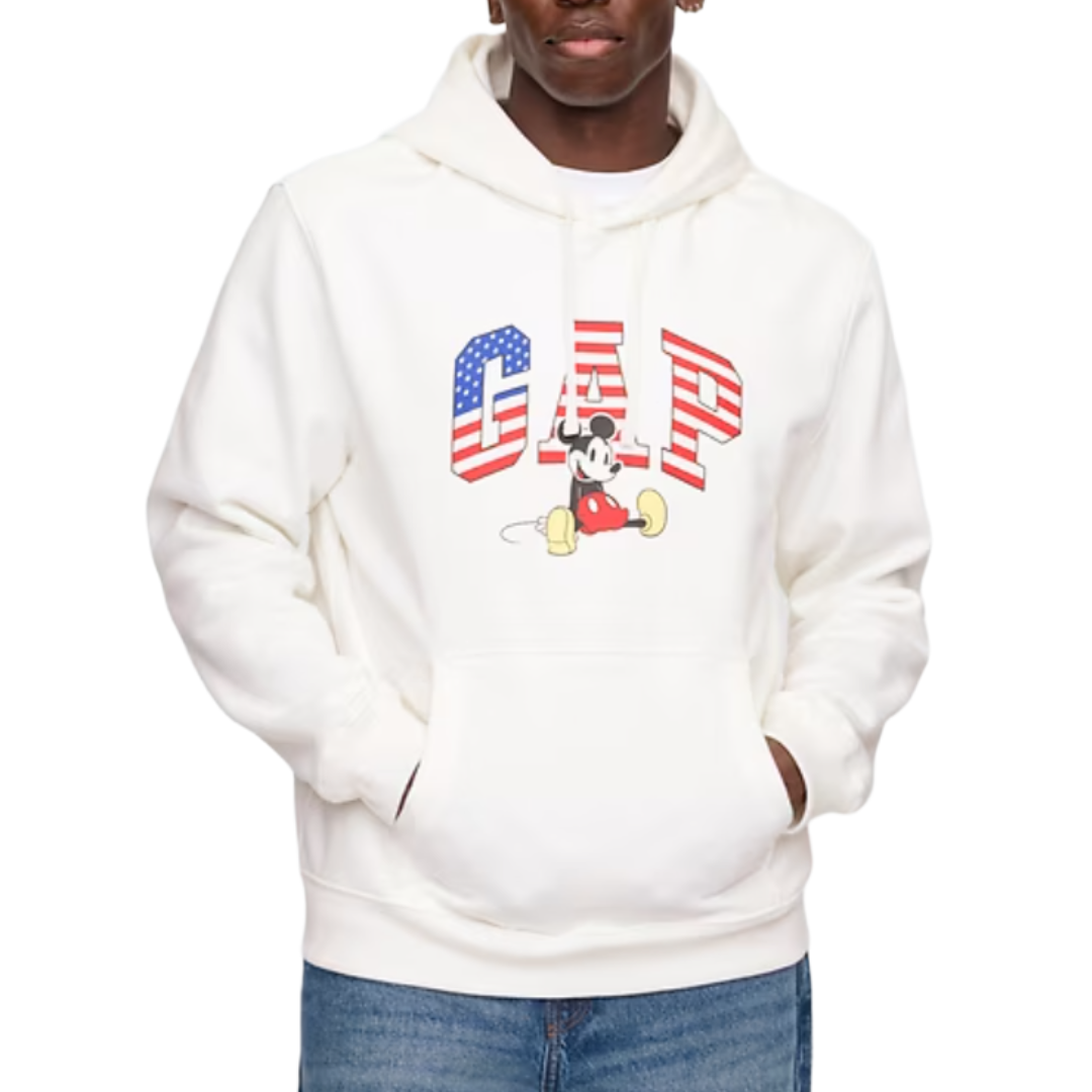 White hoodie featuring the GAP logo with an American flag design and an image of Mickey Mouse, paired with blue jeans.