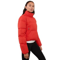 A red, high-neck puffer jacket with long sleeves and a slightly cropped fit, featuring a zip-up front and side pockets, worn with black leggings.