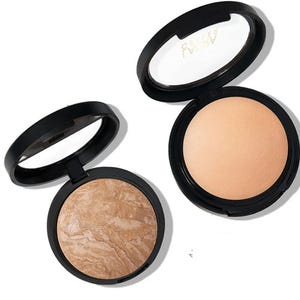 Two compact powders in black cases, one with a marbled brown shade and the other in a solid beige tone.