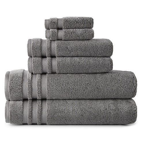 A stack of gray towels in varying sizes, neatly arranged from largest to smallest.