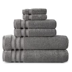 A stack of gray towels in varying sizes, neatly arranged from largest to smallest.