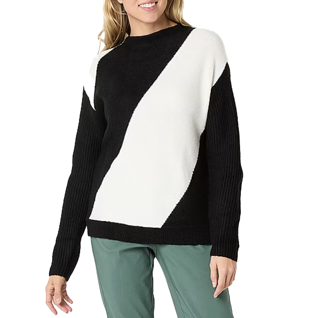 A black and white sweater featuring a bold diagonal stripe design, paired with green pants.