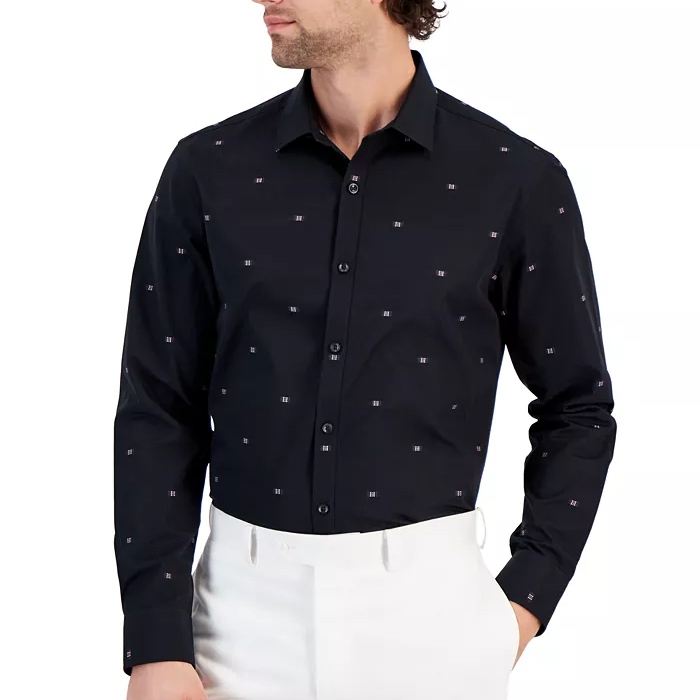 A man wearing a black button-up shirt with white dot patterns.