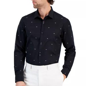 A man wearing a black button-up shirt with white dot patterns.
