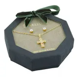 A jewelry set with a gold cross pendant necklace and matching stud earrings, displayed in an octagonal green box with a bow.