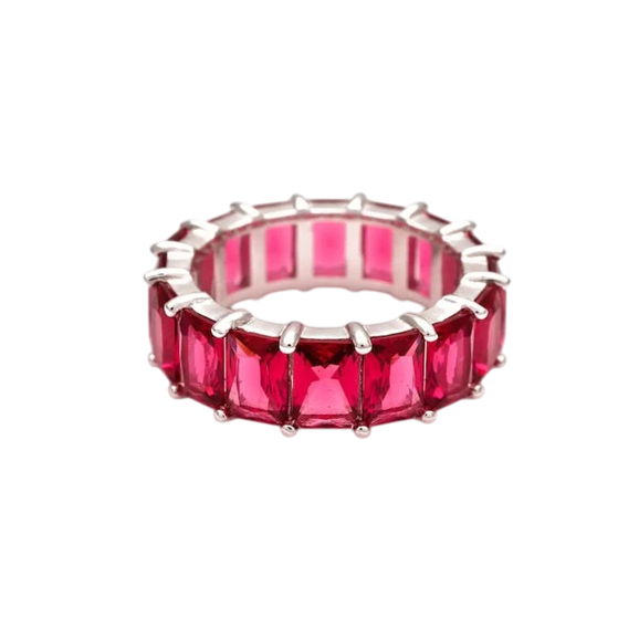 A silver ring featuring a continuous row of rectangular, vibrant pink gemstones, set in a prong setting for an elegant eternity design.