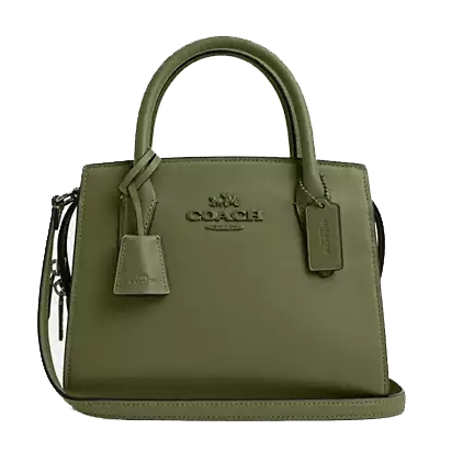 Olive green leather Coach Outlet carryall bag featuring dual top handles, a detachable shoulder strap, and two leather tags. It has the Coach logo embossed on the front.