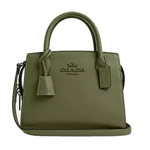 Olive green leather Coach Outlet carryall bag featuring dual top handles, a detachable shoulder strap, and two leather tags. It has the Coach logo embossed on the front.