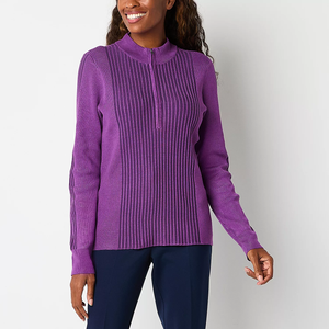 Woman wearing a purple zippered ribbed sweater and navy pants.