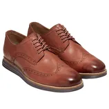 Brown leather wingtip Oxford shoes with brogue detailing and a dark sole.