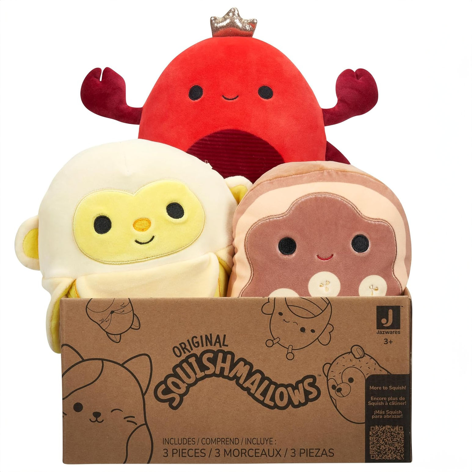 Three Squishmallows: a red crab with a crown, a yellow monkey, and a brown piece of toast with banana slices, in a box labeled \“Original Squishmallows\“ from Jazwares.