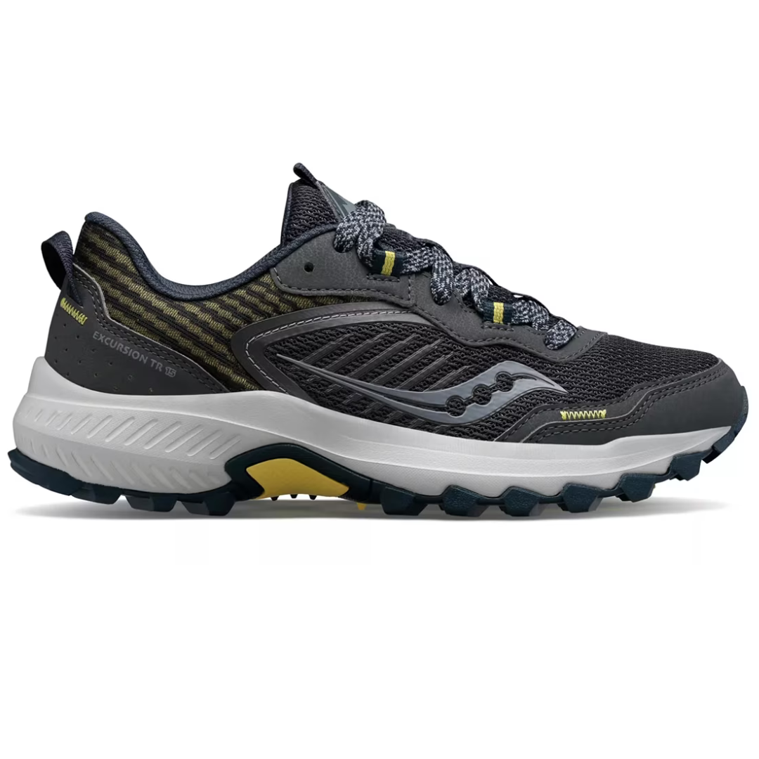Saucony Excursion TR15 Trail Runners are dark gray with accents of yellow and gray on the sole and laces. Designed for trail running, they feature a rugged outsole for grip and a mesh upper for breathability.