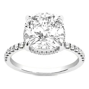 A white gold engagement ring featuring a large cushion-cut diamond in the center, with smaller diamonds encrusted along the band.