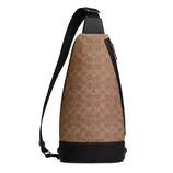 Brown sling bag with a monogram pattern and a black adjustable strap and base.