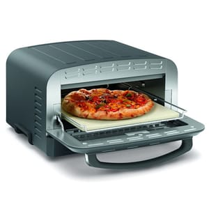 A compact pizza oven with a pull-out tray holds a cooked pizza on a baking stone.