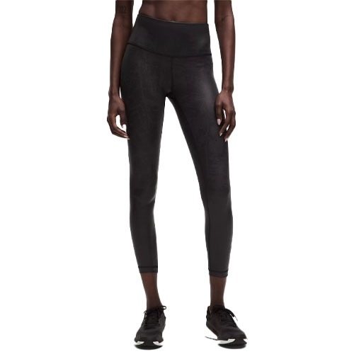 Black high-waisted leggings with a three-quarter length, paired with black athletic shoes.