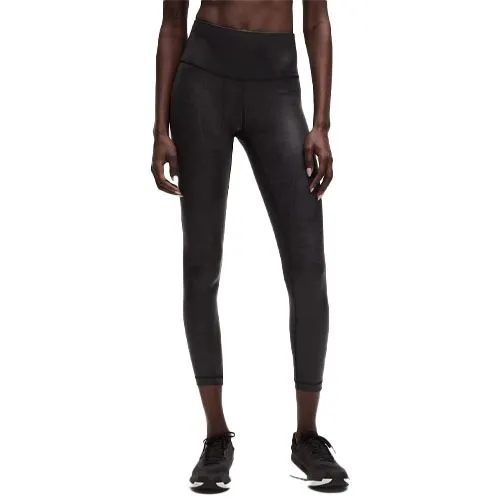 Black high-waisted leggings with a three-quarter length, paired with black athletic shoes.