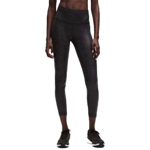 Black high-waisted leggings with a three-quarter length, paired with black athletic shoes.
