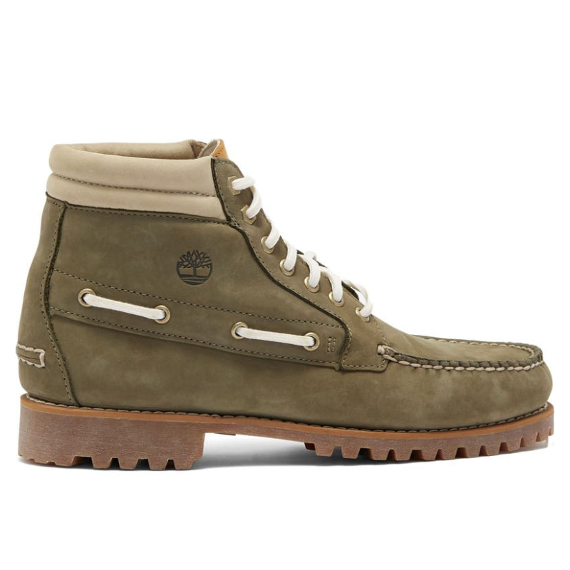 Timberland Men's Chukka Boots in olive green feature a moc toe design with white laces and stitching, a padded ankle collar, and a rugged brown rubber outsole. They have a side logo detail and eyelet accents for added style.