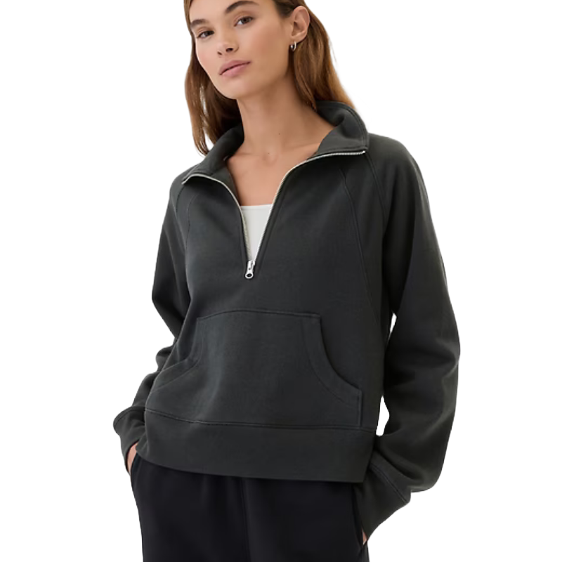 A relaxed, dark charcoal fleece quarter-zip sweatshirt with a visible front zipper and a kangaroo pocket. It features long sleeves and a soft, comfortable fit.