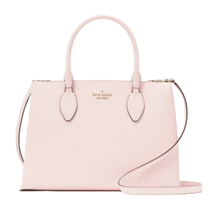 A light pink Kate Spade Rae Medium Satchel featuring dual top handles, a detachable shoulder strap, and a structured silhouette with gold-tone logo detailing on the front.